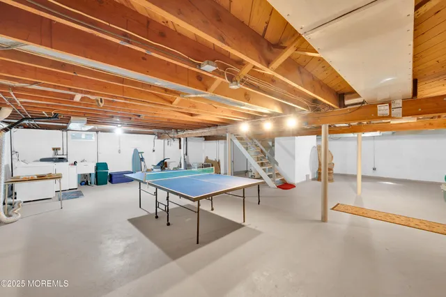 a living room with a pool table and chairs