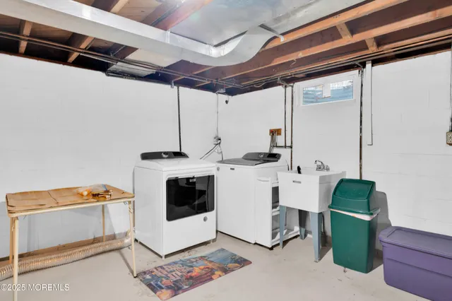 a view of kitchen with furniture and electronic appliances