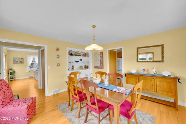 a dining room with furniture and wooden floor