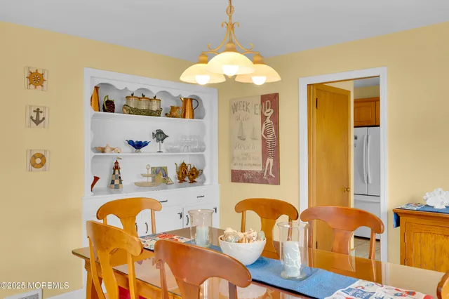 a dining room with furniture and chandelier