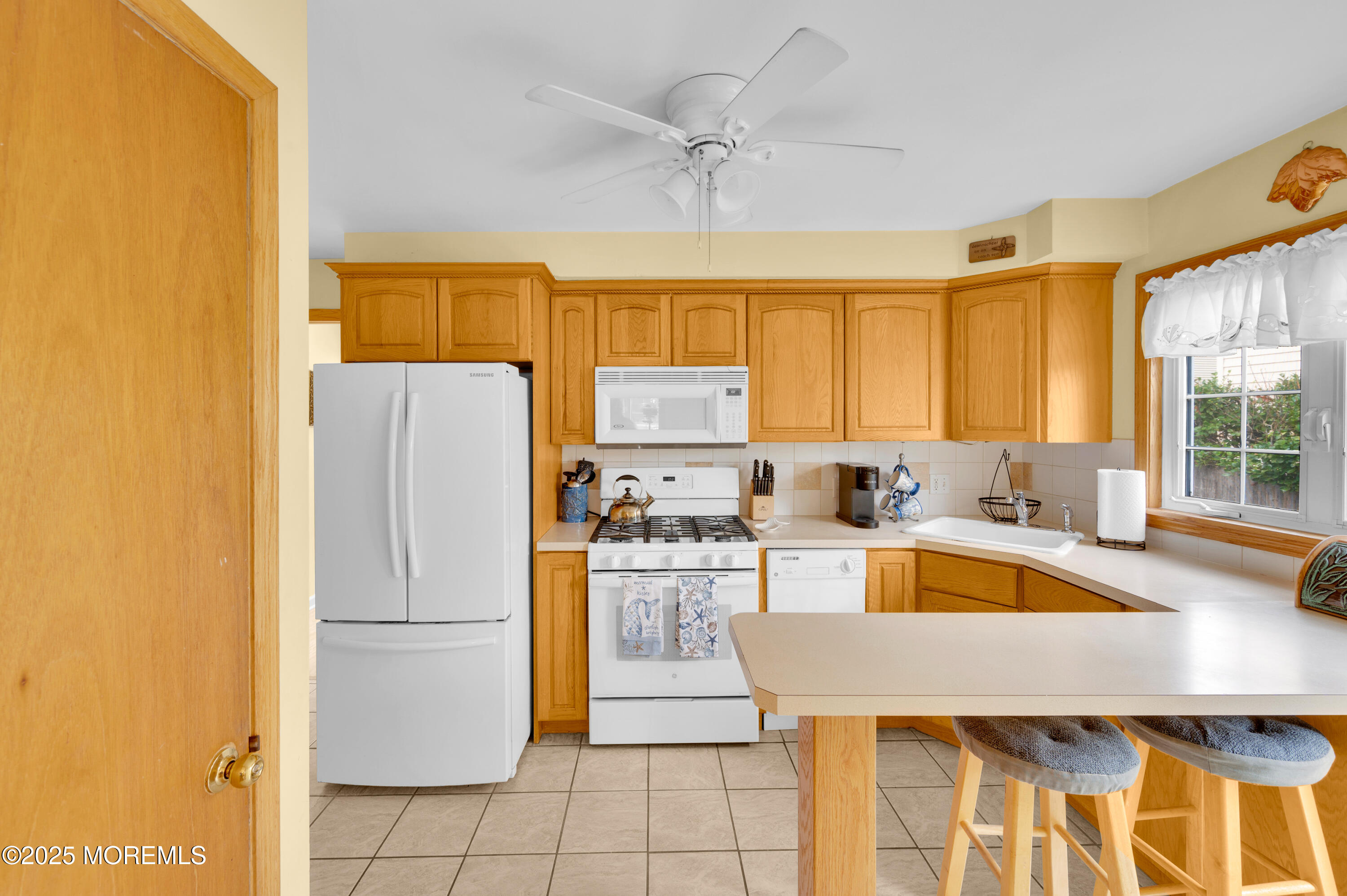 2203 3rd Avenue Spring Lake, NJ 07762 - Photo 8 of 27 a kitchen with a refrigerator a stove top oven a sink and cabinets