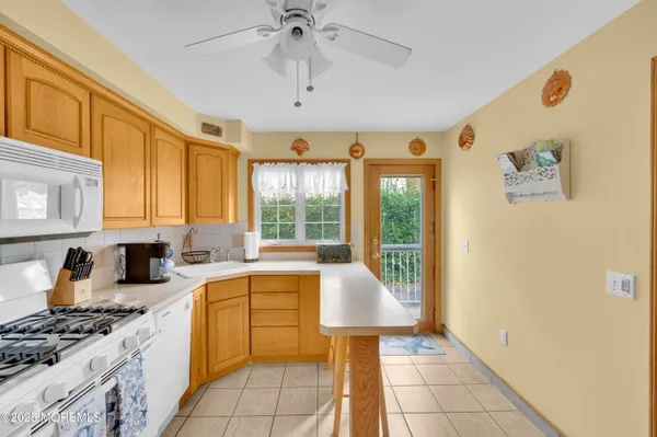 a kitchen with a sink a stove top oven and cabinetry