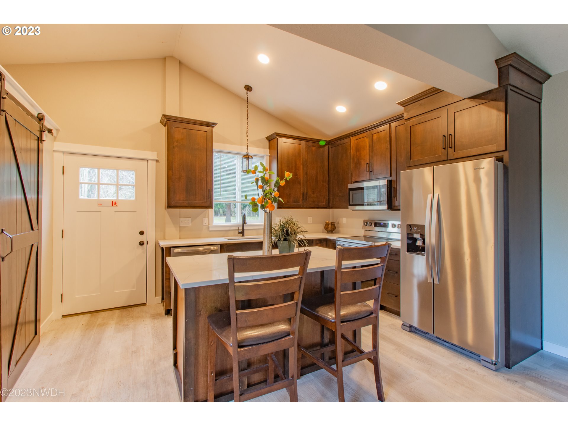 1625 River Loop 1 Eugene, OR 97404 - Photo 19 of 32 a kitchen with a refrigerator a table and chairs