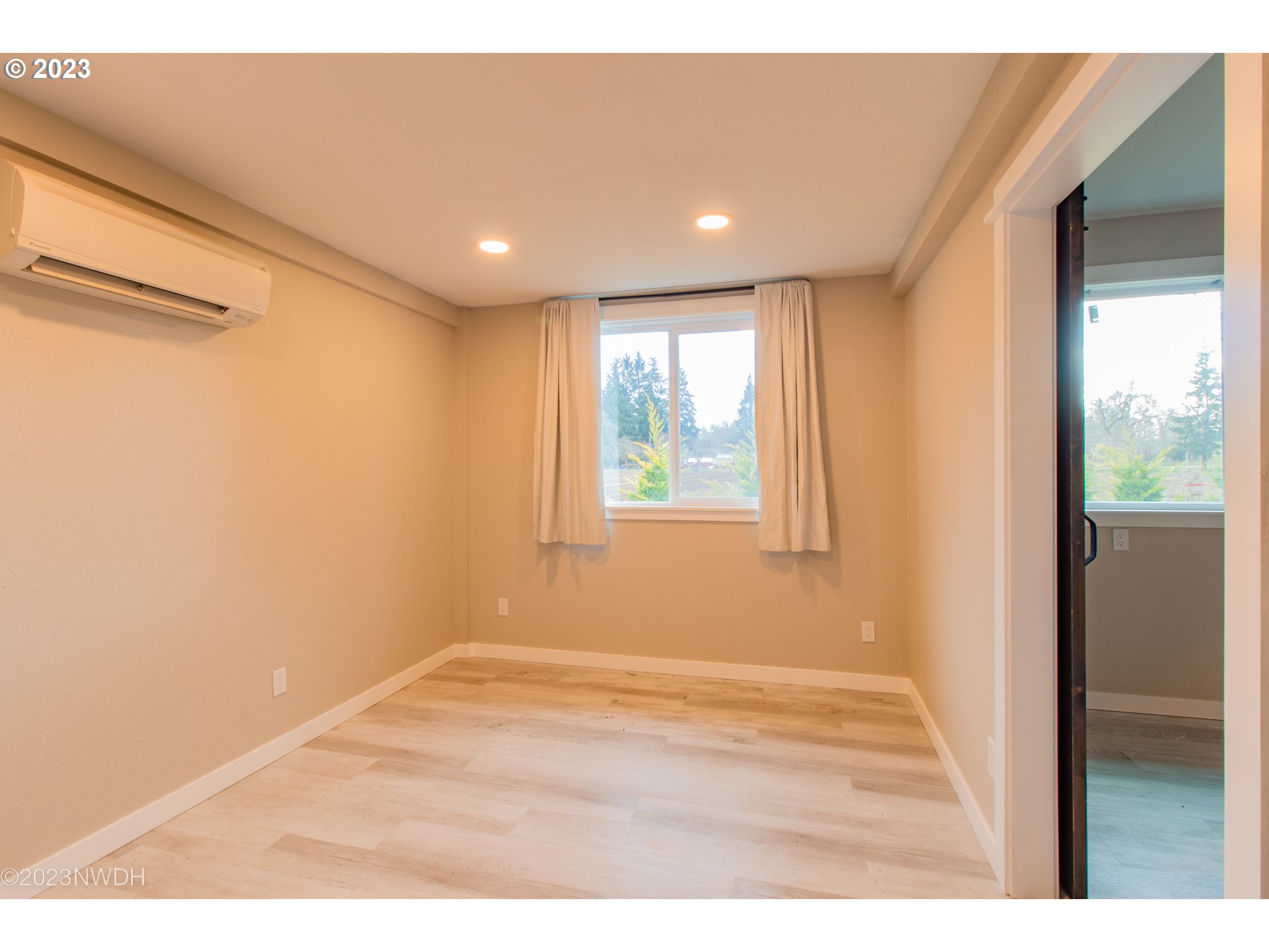 1625 River Loop 1 Eugene, OR 97404 - Photo 24 of 32 a view of an empty room with wooden floor and a window