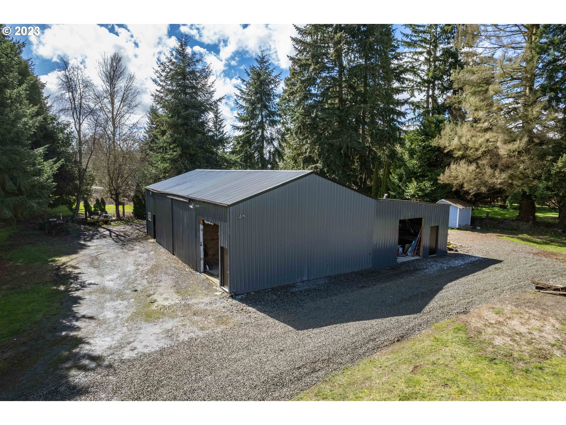 1625 River Loop 1 Eugene, OR 97404 - Photo 25 of 32 a backyard of a house with a yard and garage