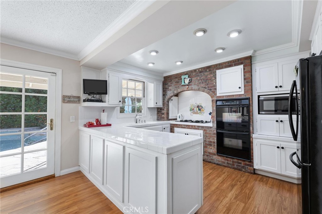 10800 Bismarck Avenue Porter Ranch, CA 91326 - Photo 11 of 29 a kitchen with stainless steel appliances a stove refrigerator sink and microwave