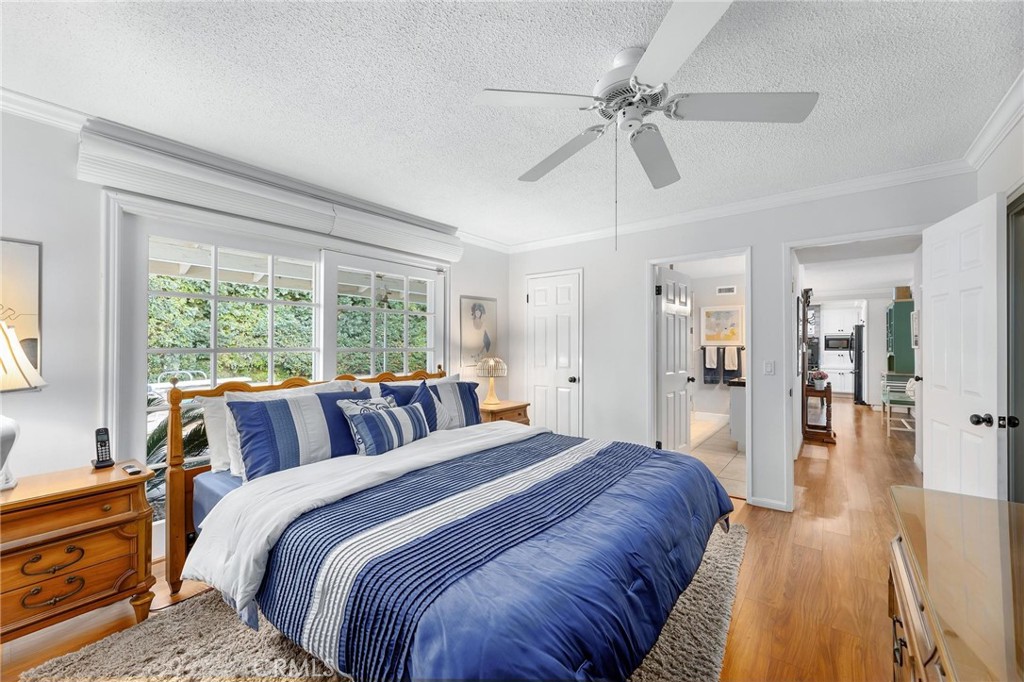 10800 Bismarck Avenue Porter Ranch, CA 91326 - Photo 19 of 29 a bedroom with a large bed and a chandelier