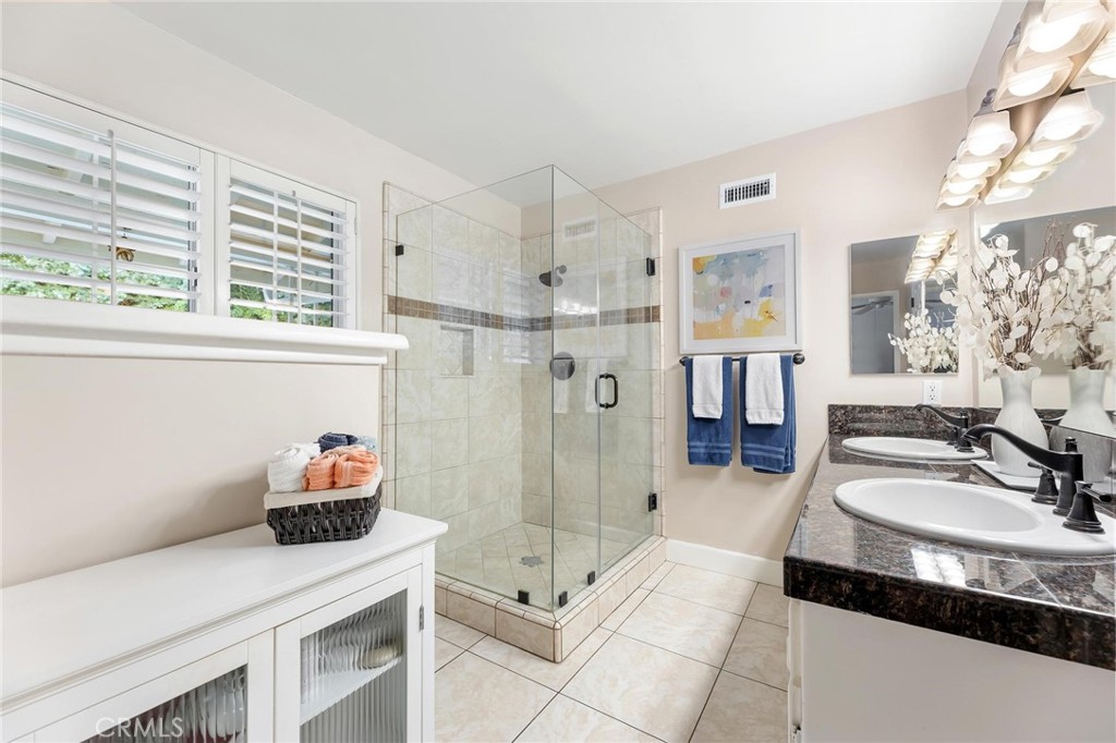 10800 Bismarck Avenue Porter Ranch, CA 91326 - Photo 20 of 29 a bathroom with a sink double vanity and shower