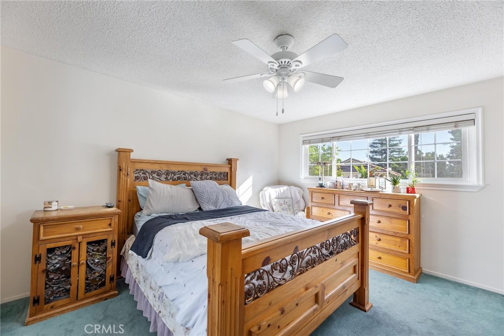 10800 Bismarck Avenue Porter Ranch, CA 91326 - Photo 22 of 29 a bedroom with a bed and a chandelier
