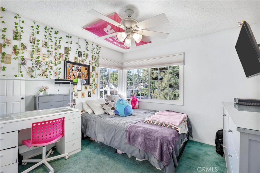 10800 Bismarck Avenue Porter Ranch, CA 91326 - Photo 24 of 29 a bedroom with a bed a flat screen tv and a dresser