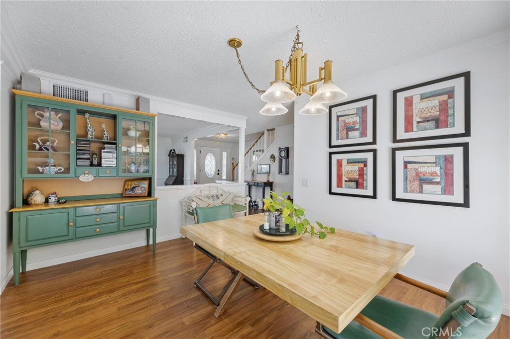 10800 Bismarck Avenue Porter Ranch, CA 91326 - Photo 10 of 29 a view of a dining room with furniture a chandelier and wooden floor