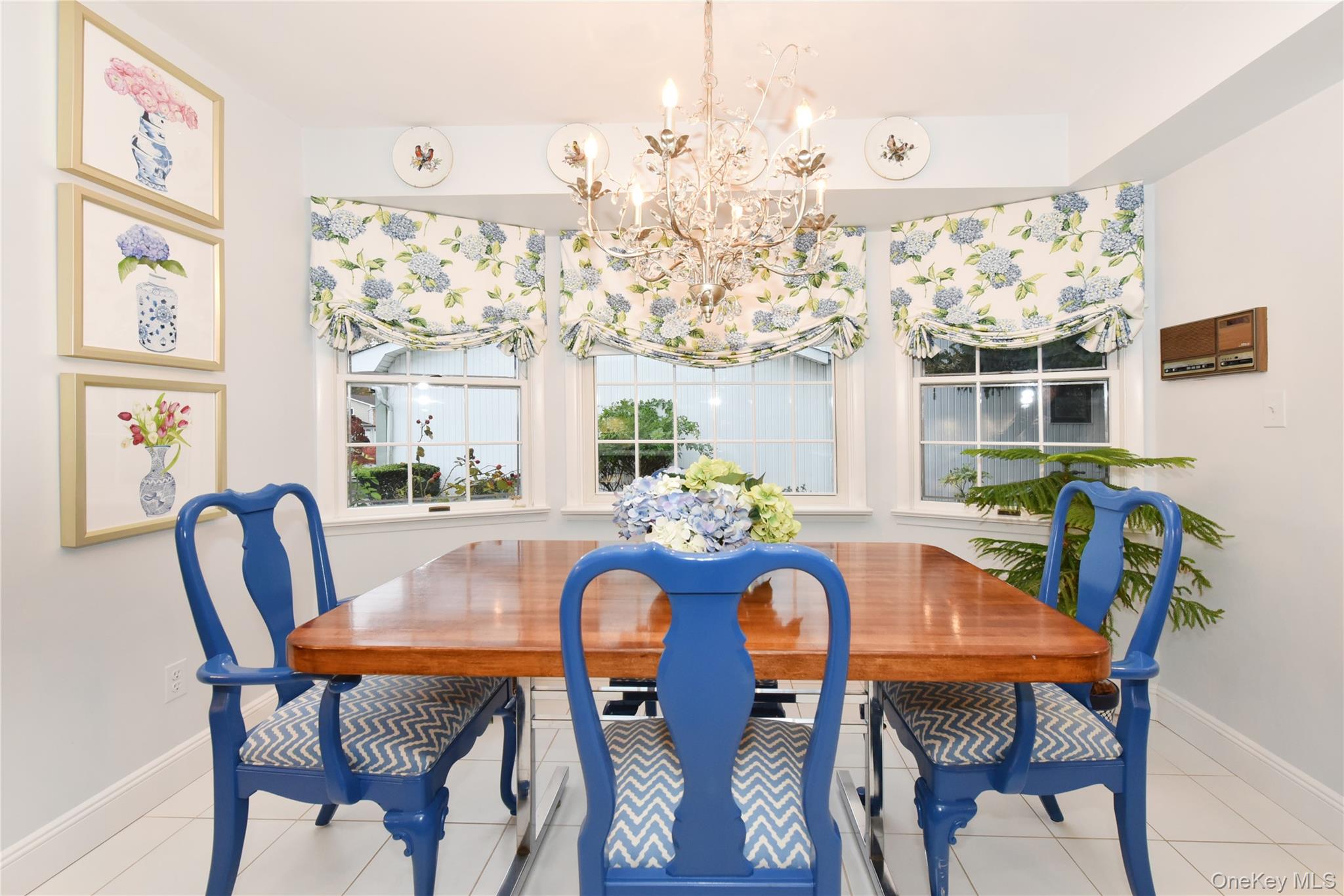 11 Joy Drive Manhasset Hills, NY 11040 - Photo 11 of 41 a view of a dining room with furniture large window and wooden floor