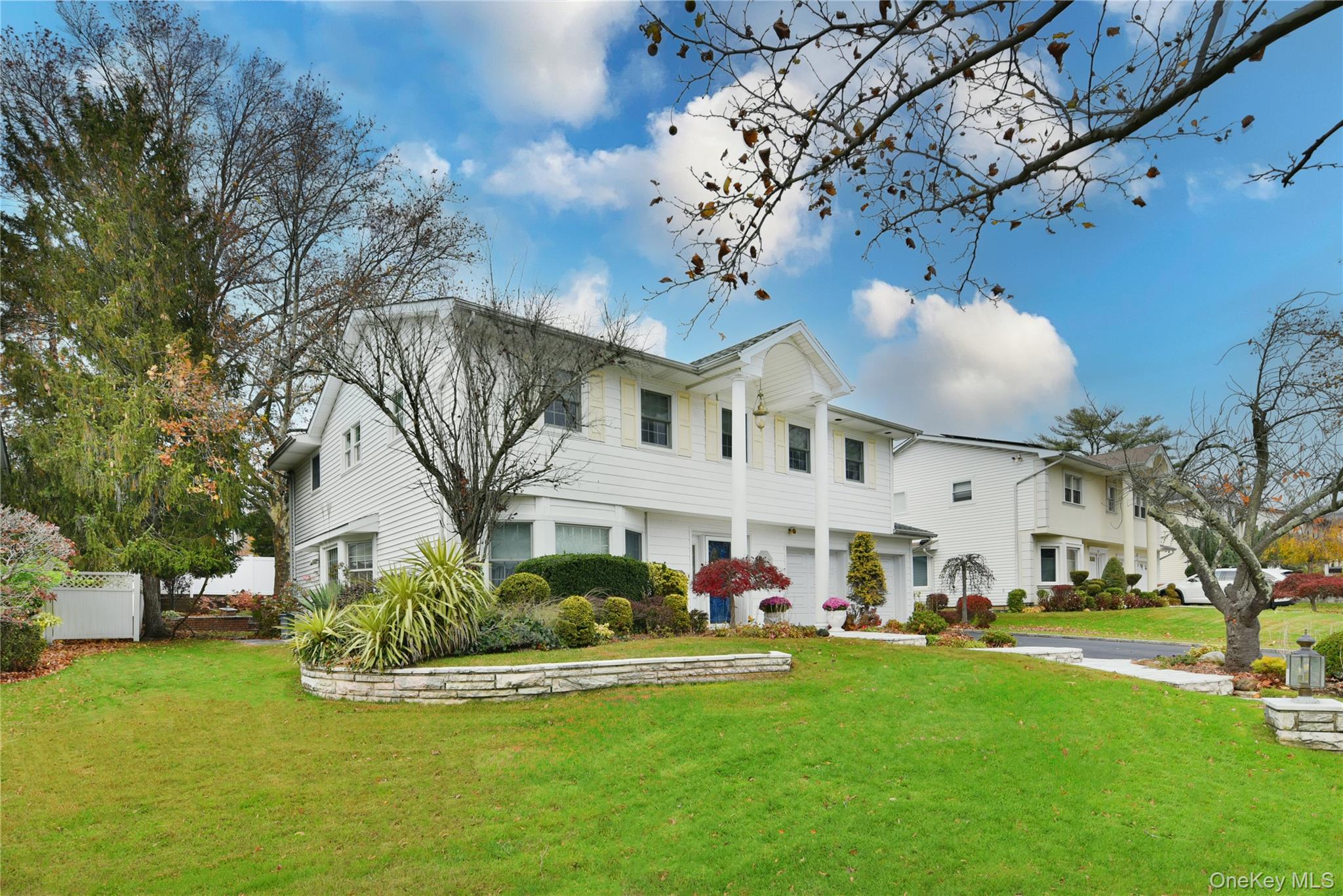 11 Joy Drive Manhasset Hills, NY 11040 - Photo 2 of 41 a view of a white house with a big yard and a large tree