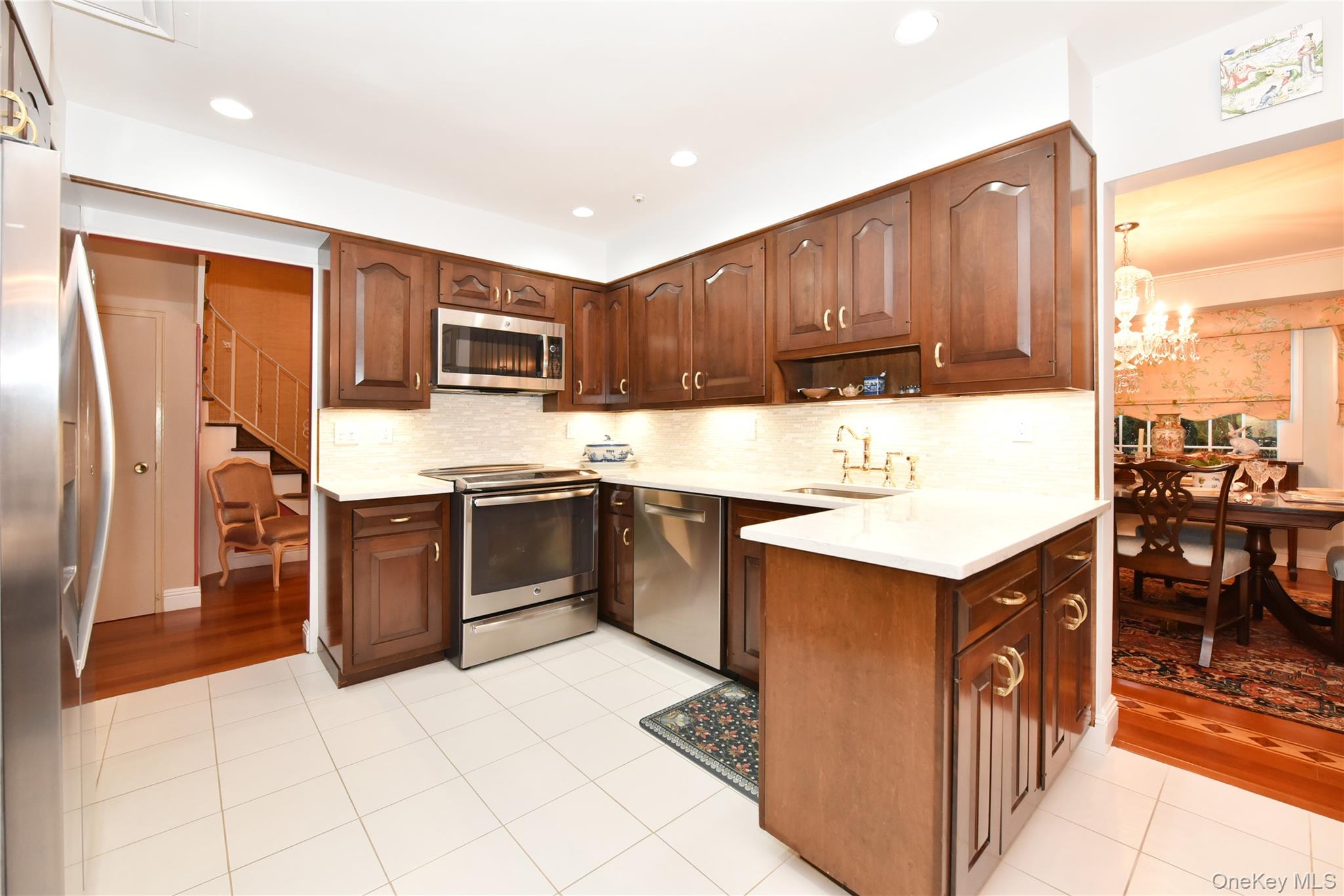 11 Joy Drive Manhasset Hills, NY 11040 - Photo 7 of 41 a kitchen with stainless steel appliances granite countertop a stove top oven a refrigerator a sink and dishwasher