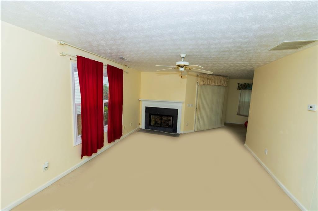 3440 Maple Valley Drive Cumming, GA 30040 - Photo 12 of 73 a view of an empty room with a fireplace