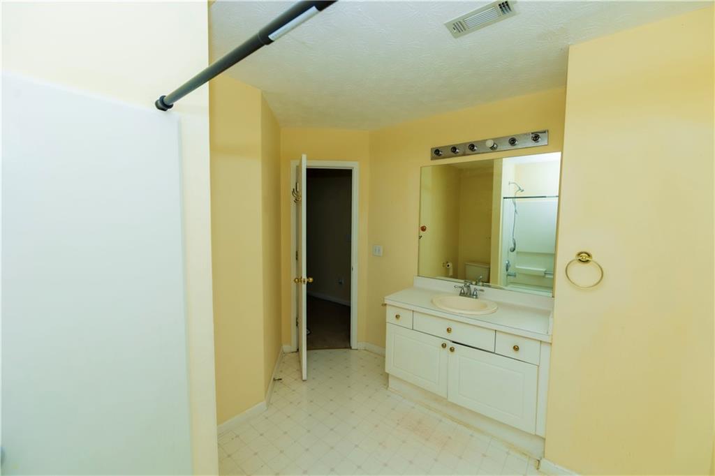 3440 Maple Valley Drive Cumming, GA 30040 - Photo 26 of 73 a bathroom with a double vanity sink and mirror