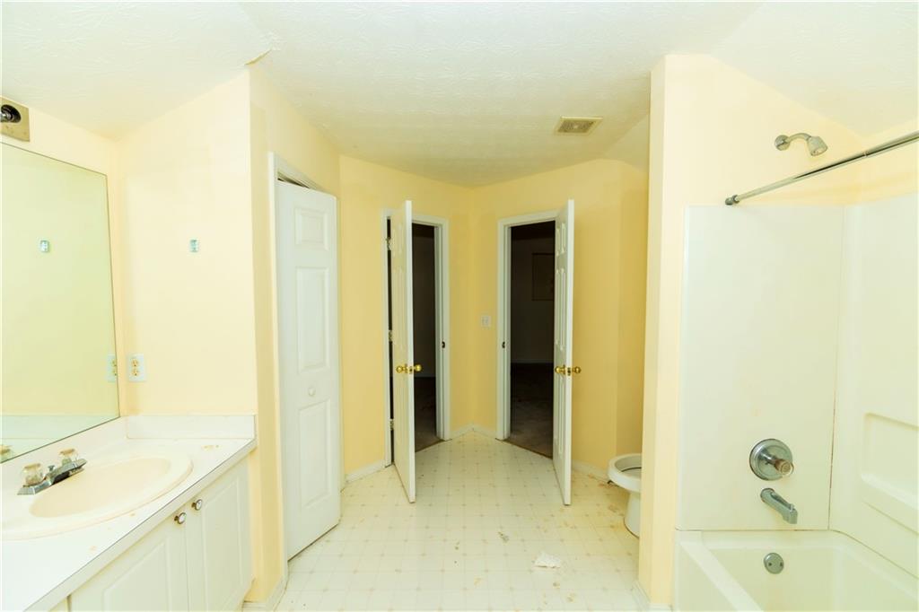 3440 Maple Valley Drive Cumming, GA 30040 - Photo 40 of 73 a bathroom with a tub sink shower and a mirror