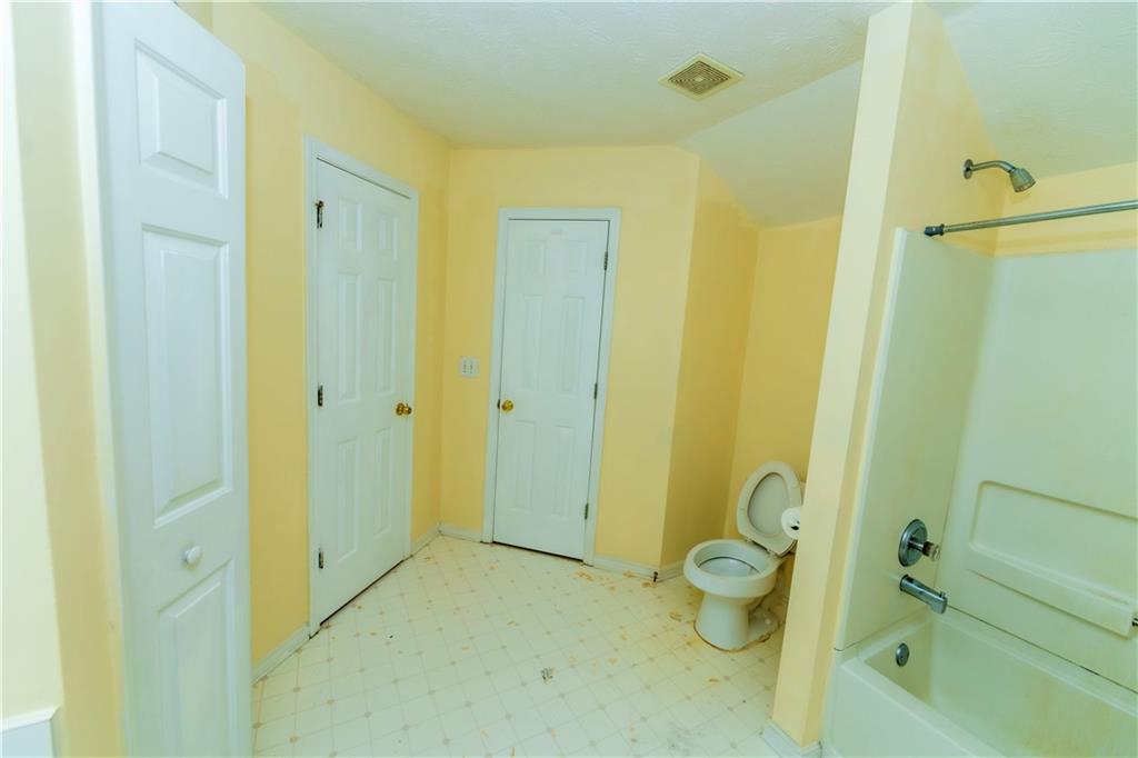 3440 Maple Valley Drive Cumming, GA 30040 - Photo 42 of 73 a bathroom with a granite countertop toilet sink and shower