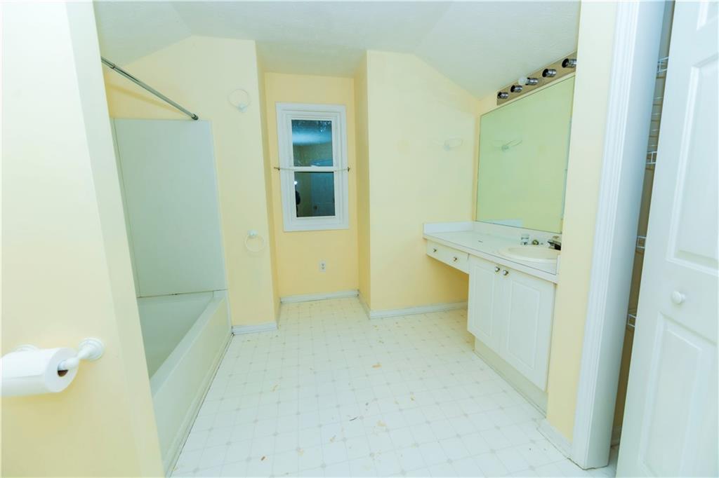 3440 Maple Valley Drive Cumming, GA 30040 - Photo 45 of 73 a bathroom with a tub sink and mirror
