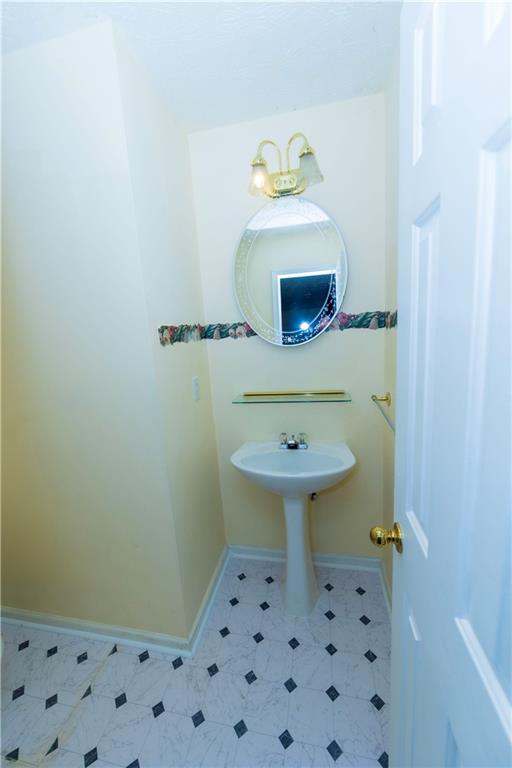 3440 Maple Valley Drive Cumming, GA 30040 - Photo 50 of 73 a bathroom with a sink a toilet and a mirror