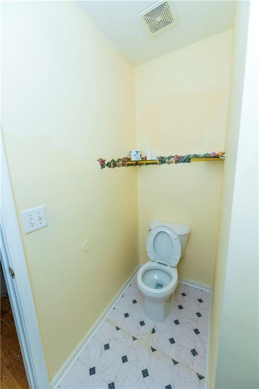 3440 Maple Valley Drive Cumming, GA 30040 - Photo 6 of 73 a bathroom with a toilet and a shower