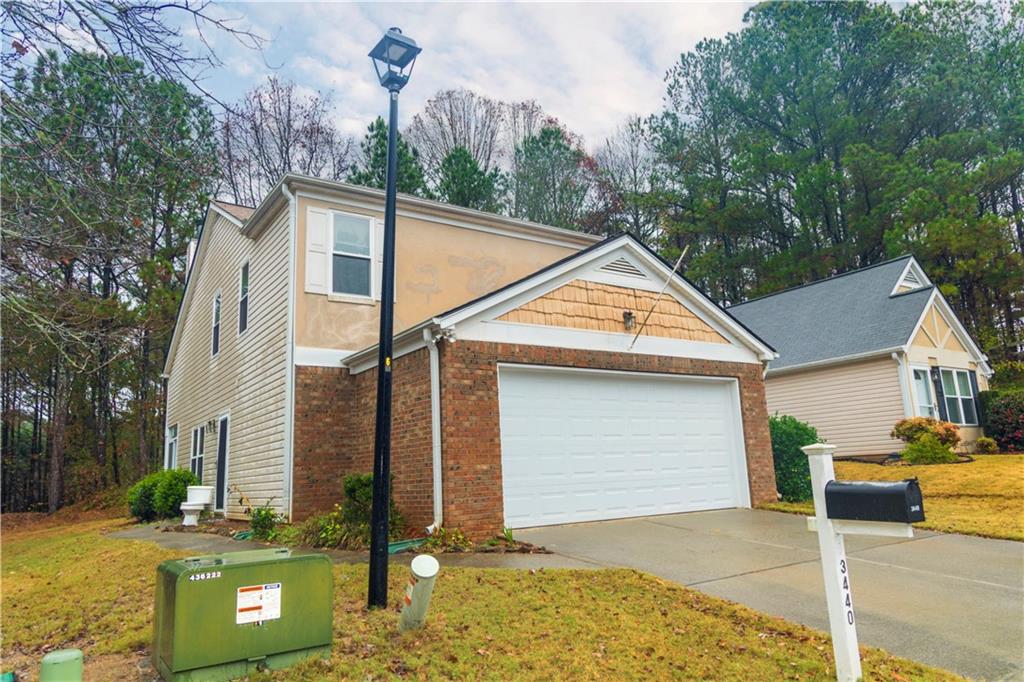 3440 Maple Valley Drive Cumming, GA 30040 - Photo 66 of 73 a view of a white house next to a yard with road and trees