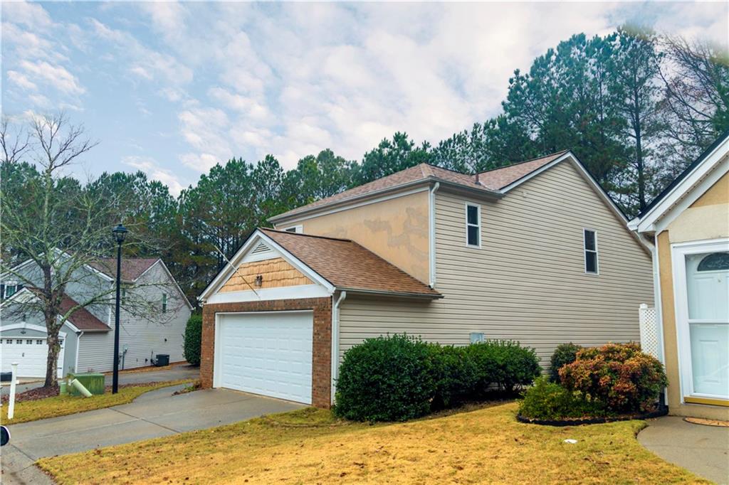 3440 Maple Valley Drive Cumming, GA 30040 - Photo 68 of 73 a view of a white house next to a yard with big trees