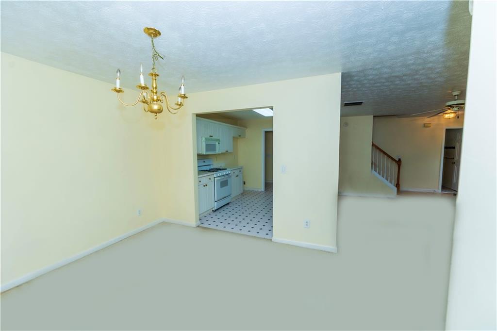 3440 Maple Valley Drive Cumming, GA 30040 - Photo 8 of 73 a view of a hallway with a chandelier