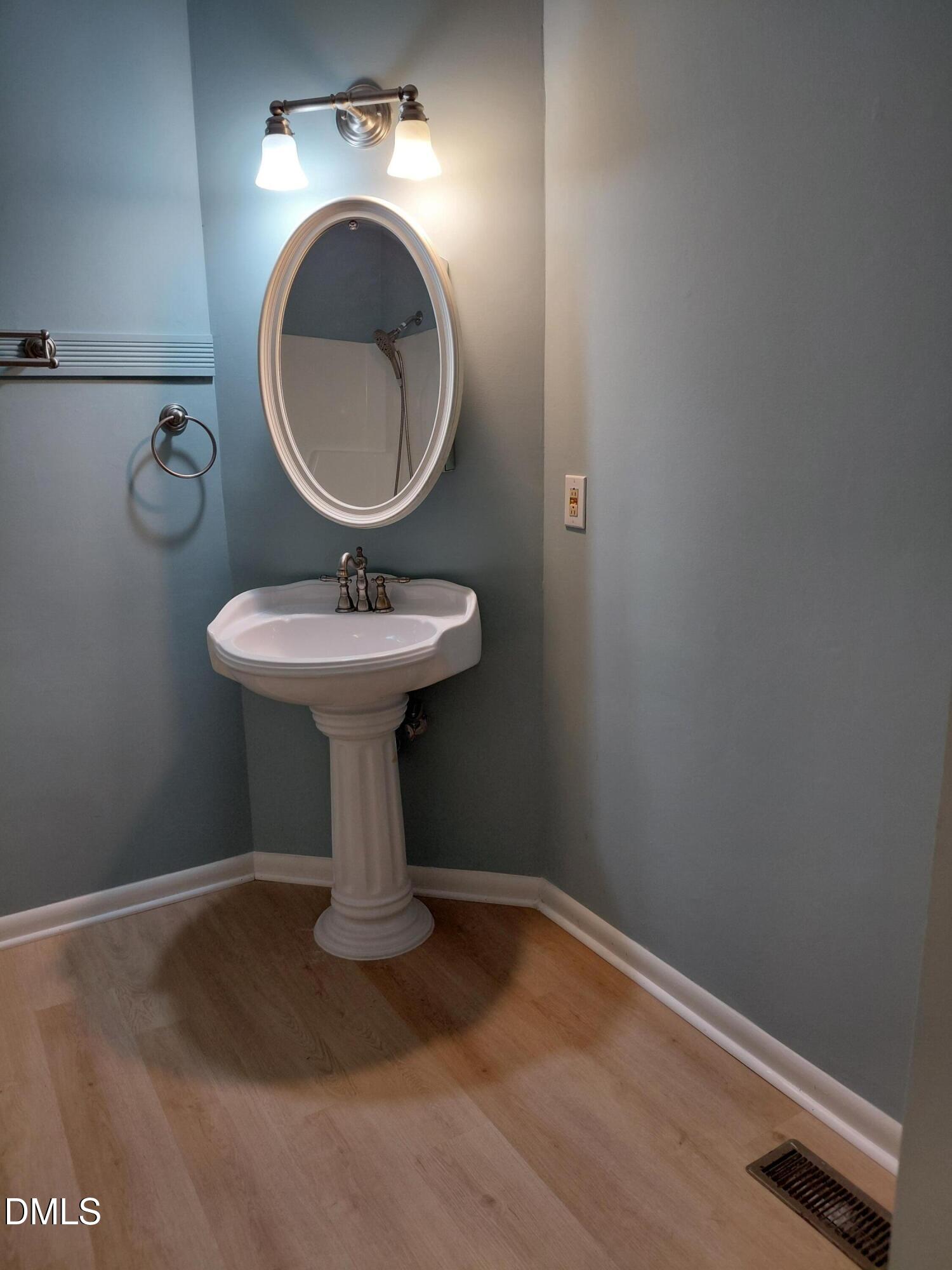 804 Olive Street Apex, NC 27502 - Photo 33 of 60 a bathroom with a sink toilet and a mirror