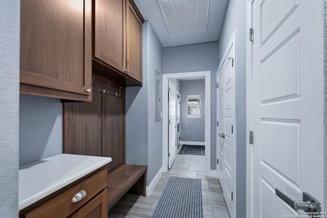 a view of a bathroom with a sink and cabinets