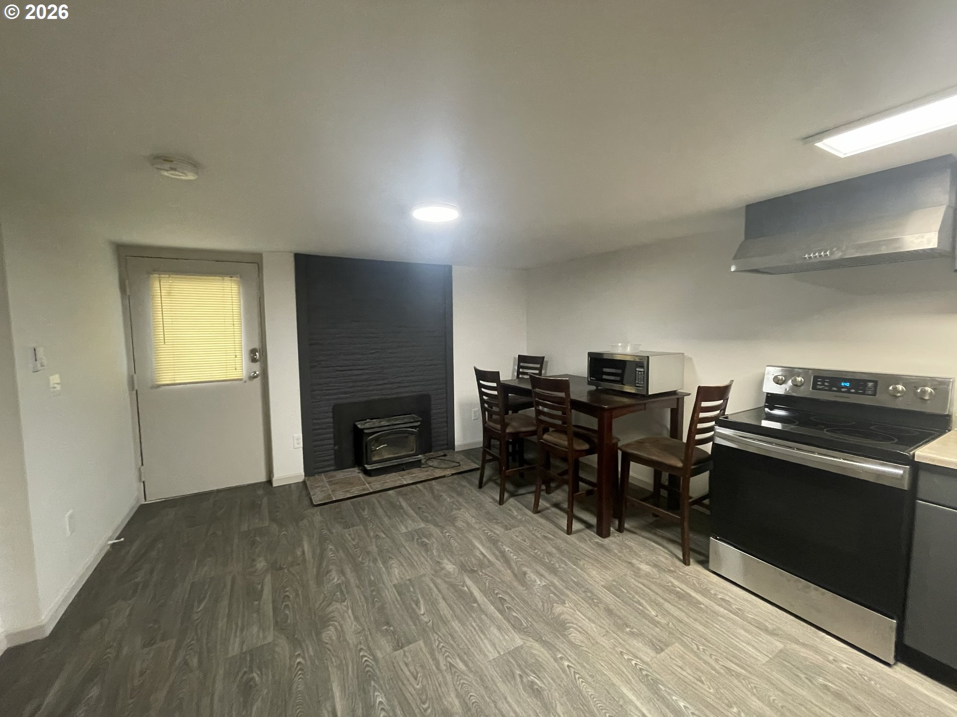 144 Southeast 85th Avenue Portland, OR 97216 - Photo 12 of 43 a workspace with furniture fireplace and a window