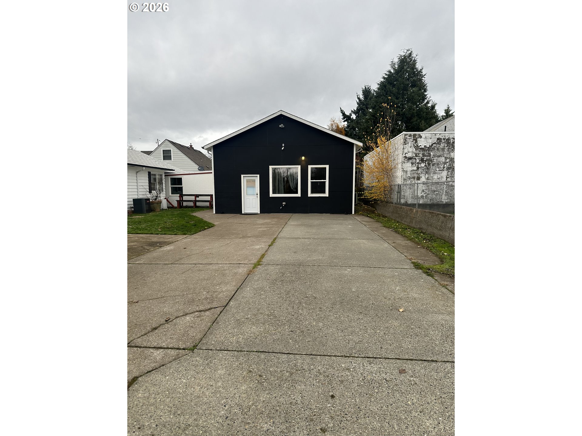 144 Southeast 85th Avenue Portland, OR 97216 - Photo 3 of 43 a view of a house with a yard and garage