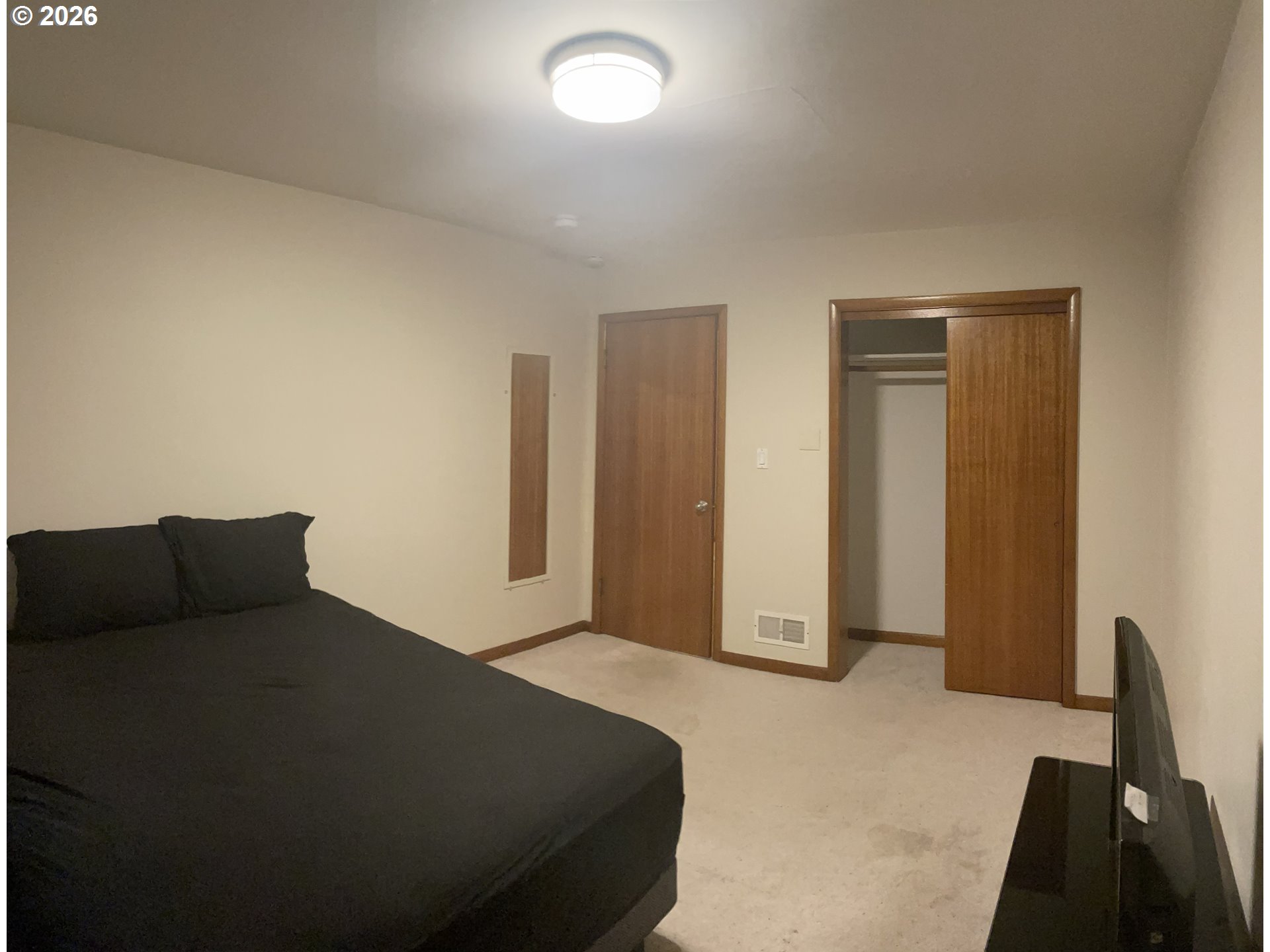 144 Southeast 85th Avenue Portland, OR 97216 - Photo 36 of 43 a bedroom with a bed and a cabinet