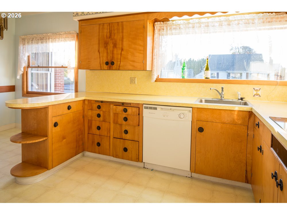 144 Southeast 85th Avenue Portland, OR 97216 - Photo 40 of 43 a kitchen with a sink and a window