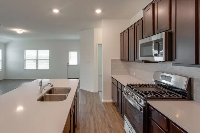 a kitchen that has a sink and a stove