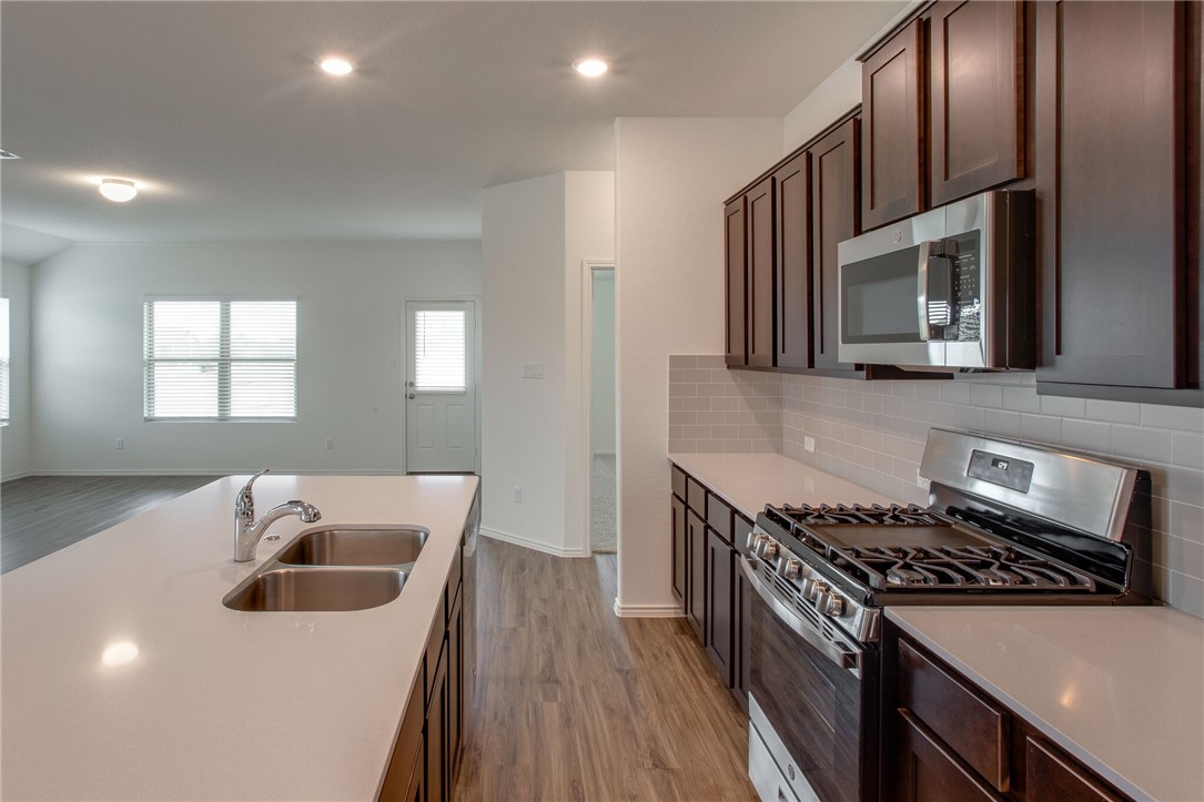3417 Pauling Loop Round Rock, TX 78665 - Photo 13 of 31 a kitchen that has a sink and a stove