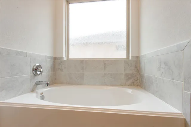 a bath tub sitting next to a window
