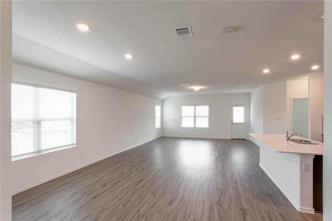 3417 Pauling Loop Round Rock, TX 78665 - Photo 5 of 31 an empty room with wooden floor and windows
