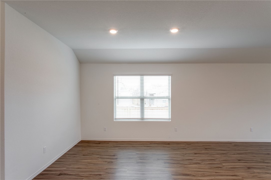3417 Pauling Loop Round Rock, TX 78665 - Photo 6 of 31 an empty room with wooden floor and windows