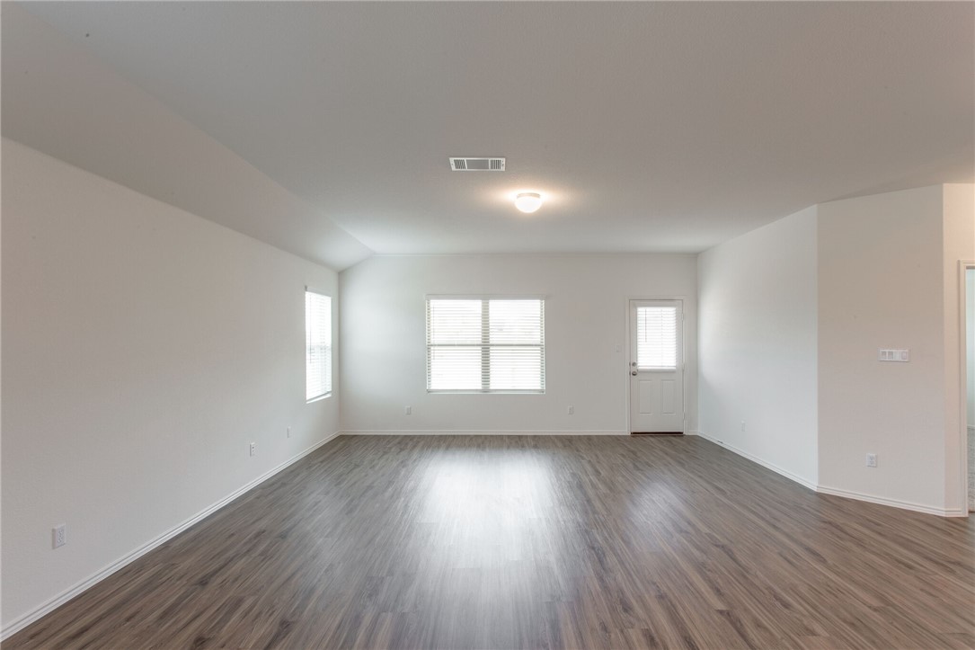 3417 Pauling Loop Round Rock, TX 78665 - Photo 8 of 31 an empty room with wooden floor and windows