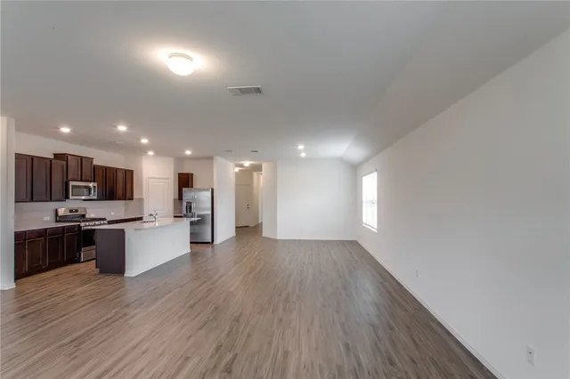 a view of a kitchen with a sink and a stove top oven