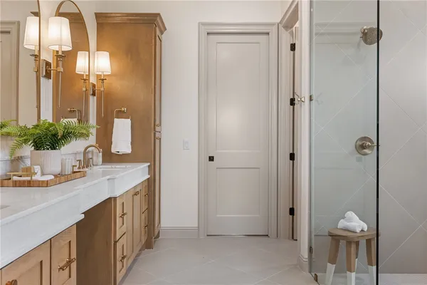 a spacious bathroom with a double vanity sink mirror and bathtub