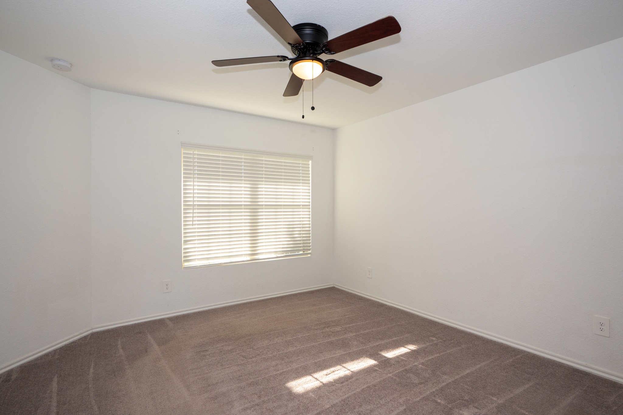 5403 Rosser Ruby Way Brookshire, TX 77423 - Photo 13 of 39 an empty room with a window and a fan