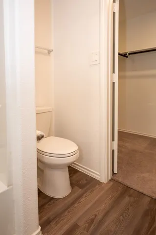a white toilet sitting next to a shower