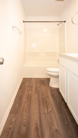 a bathroom with a toilet and a bathtub
