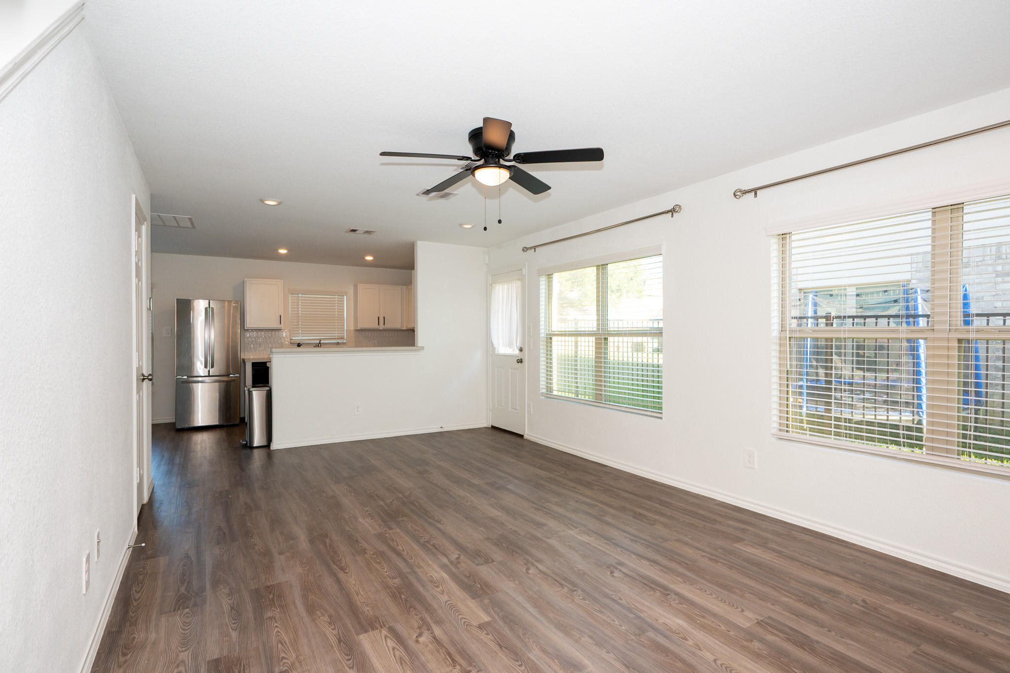 5403 Rosser Ruby Way Brookshire, TX 77423 - Photo 5 of 39 a view of a big room with wooden floor and windows