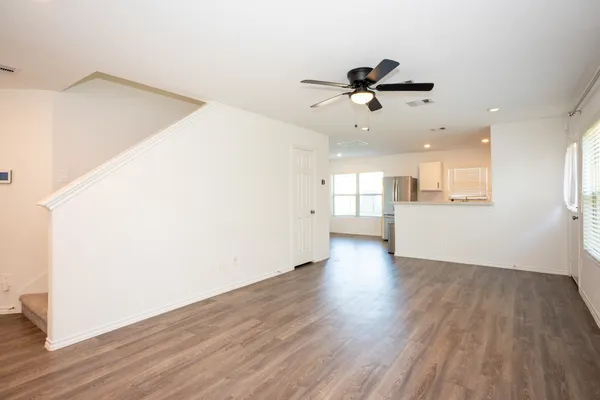 wooden floor in an empty room with a window