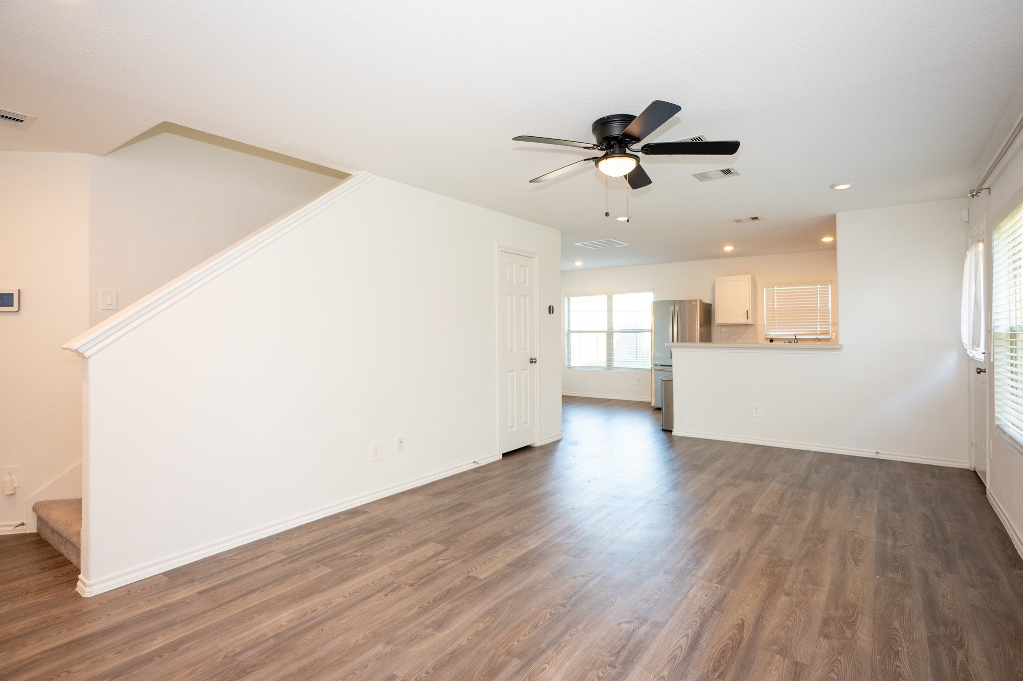 5403 Rosser Ruby Way Brookshire, TX 77423 - Photo 6 of 39 wooden floor in an empty room with a window