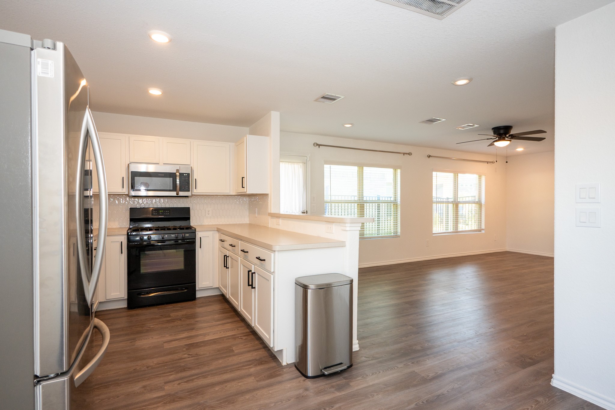 5403 Rosser Ruby Way Brookshire, TX 77423 - Photo 8 of 39 a kitchen with stainless steel appliances granite countertop a stove and a refrigerator