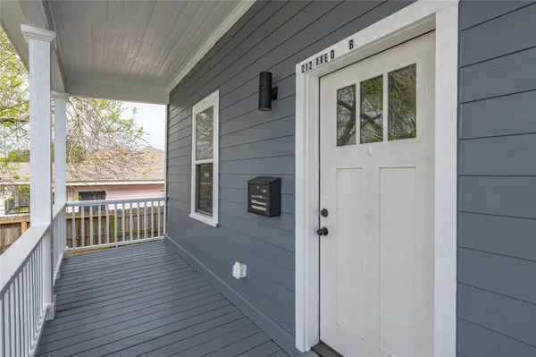 a view of a porch with wooden floor and fence